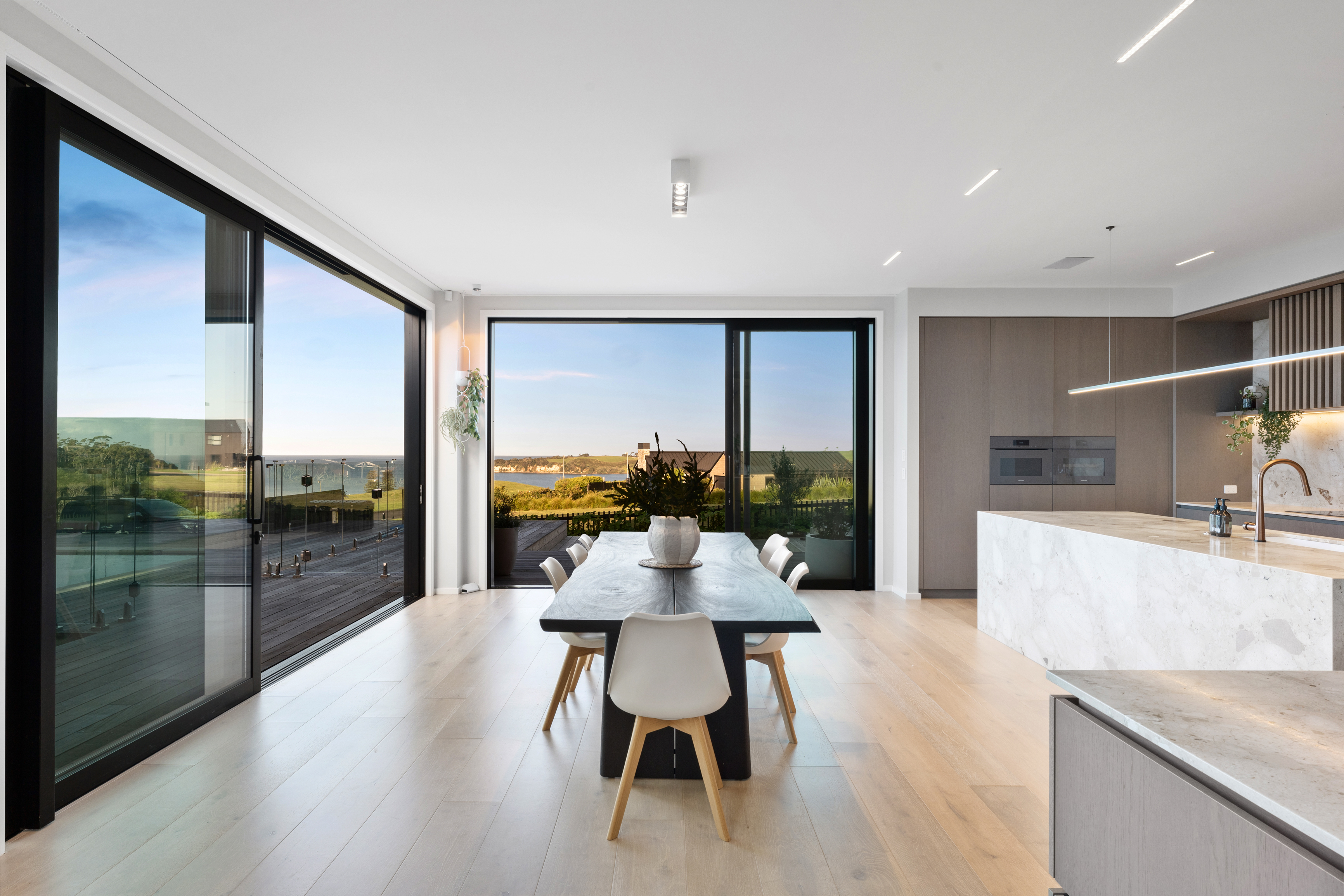 ASC Homes interior dining and kitchen space with coastal outlook